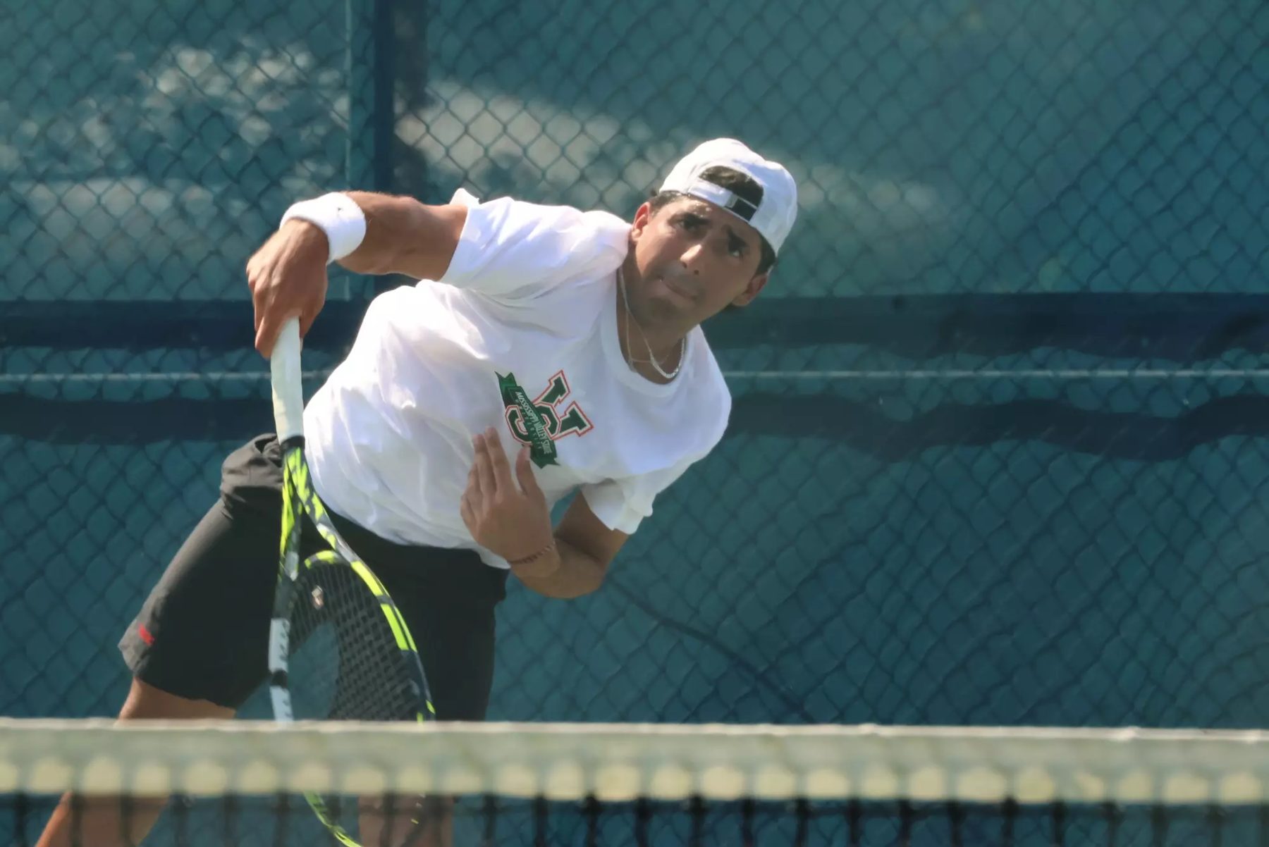 MVSU men's tennis player hitting a serve