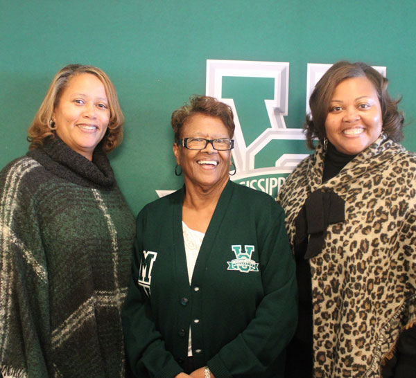 V Club supporters in front of the MVSU logo