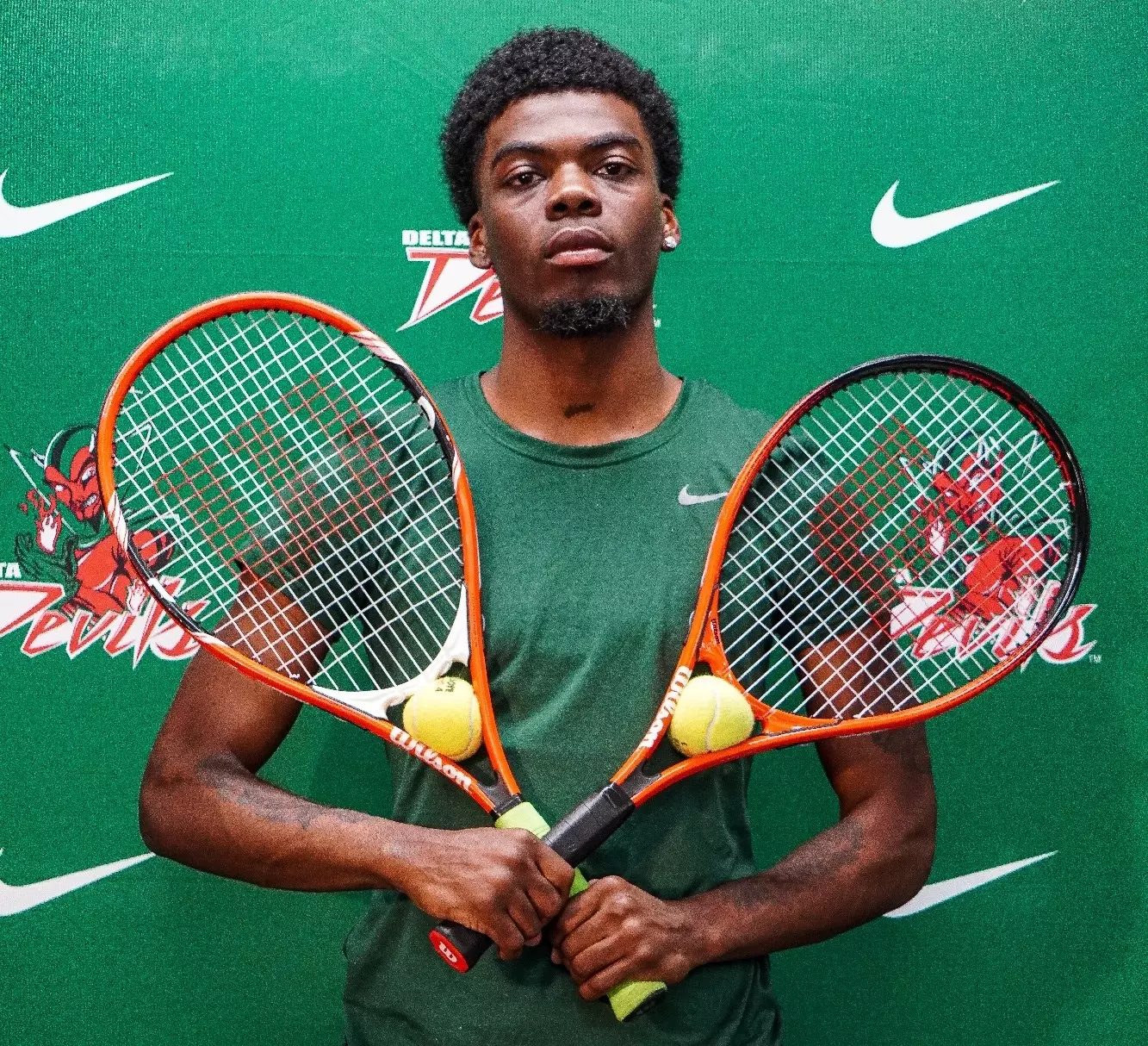 MVSU men's tennis player holding two rackets