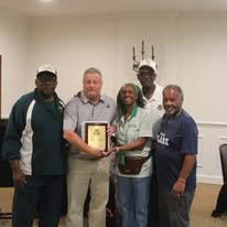V Club members presenting a plaque