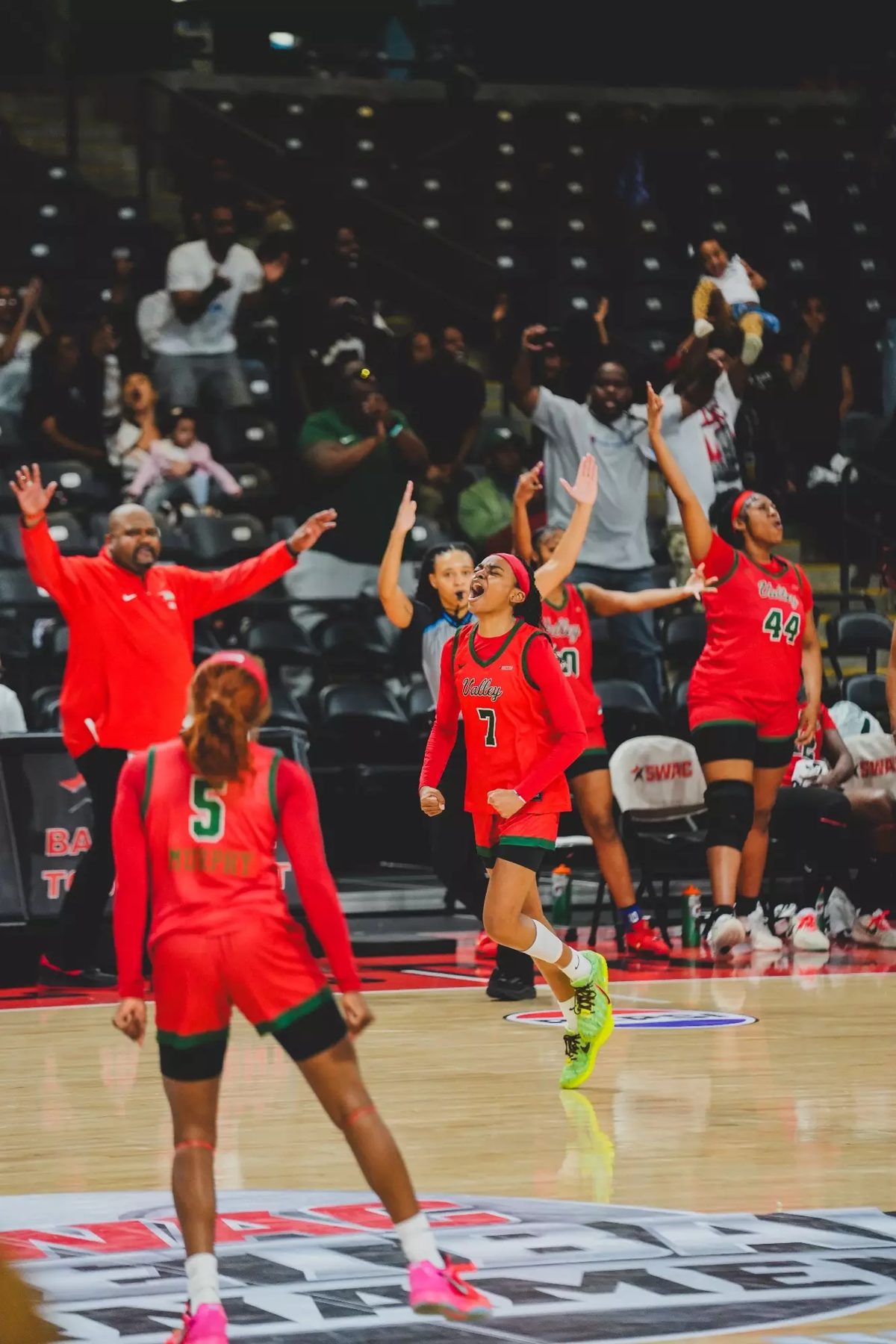 MVSU women's basketball team celebrating courtside