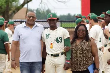 MVSU baseball player with supporters on the field
